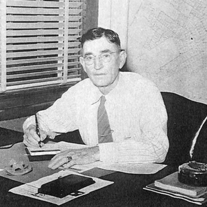 Old photo of man at a desk